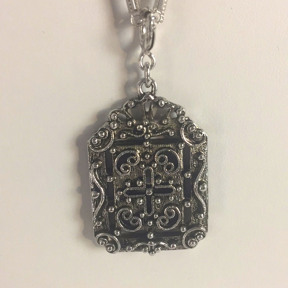 Pendant necklace.  Silver tone chain and pendant